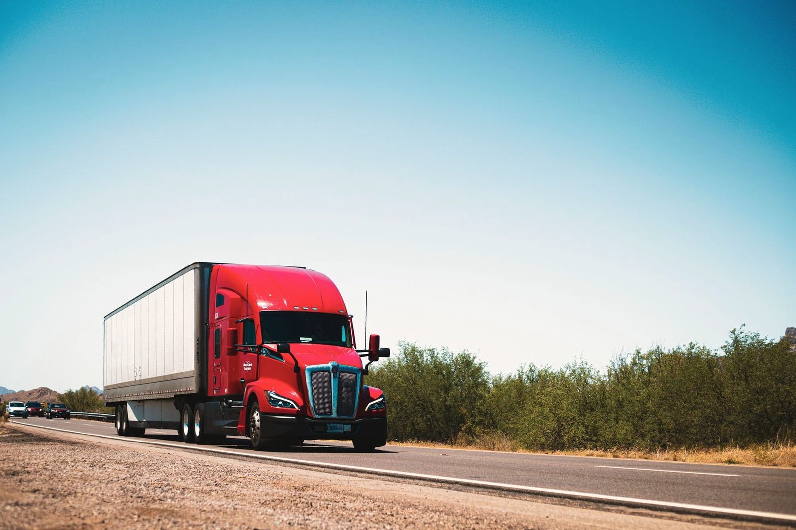 Tractor with a box trailer travelling an open highway