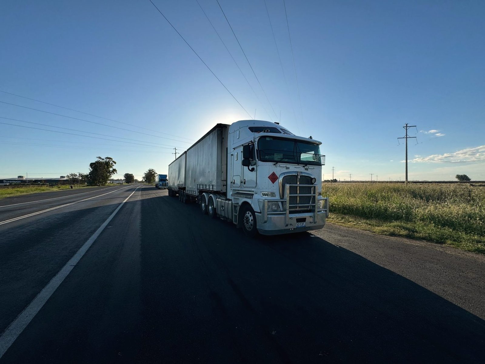 Tractor unit on a rural highway in low sun