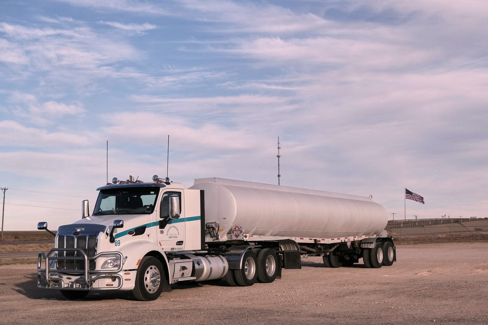 Fuel transport truck on an open highway under a wide sky